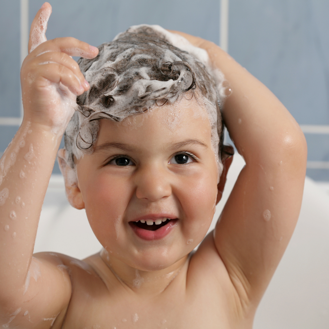 Kleinkind in der Badewanne mit sprudelndem Haar Kleinkind in der Badewanne mit sprudelndem Haar